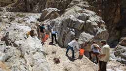 Volunteers working in the canyon above the guzzler