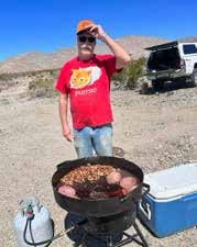 Bob Jewell cooking hamburgers on a discada